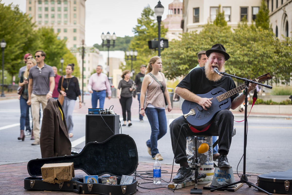Busker with guitar - Pack Square area Busker with guitar - Pack Square area