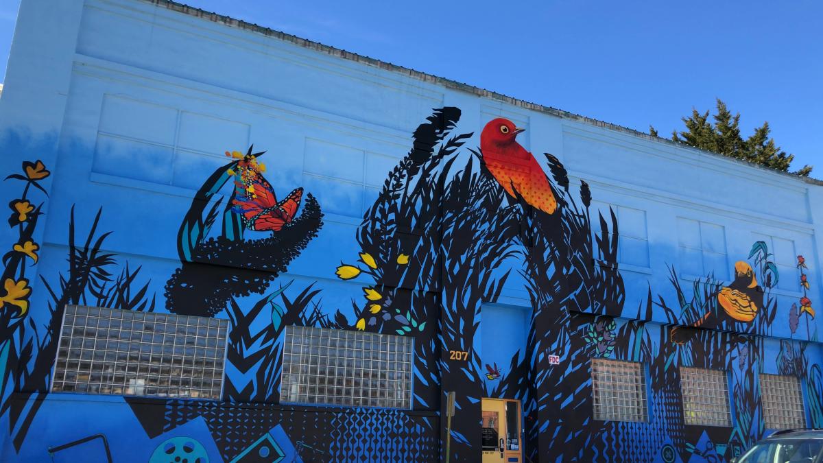 A colorful mural beckons guest to the Refinery Creator Space in Asheville, NC A colorful mural beckons guest to the Refinery Creator Space in Asheville, NC