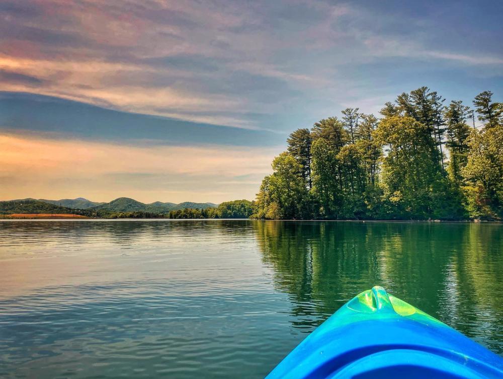 A kayak situated on Lake Julian during sunset A kayak situated on Lake Julian during sunset