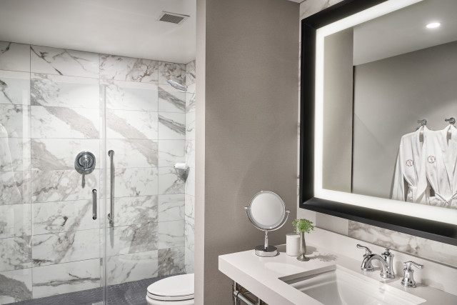 Waterfall shower heads, complimentary robes, marble accents