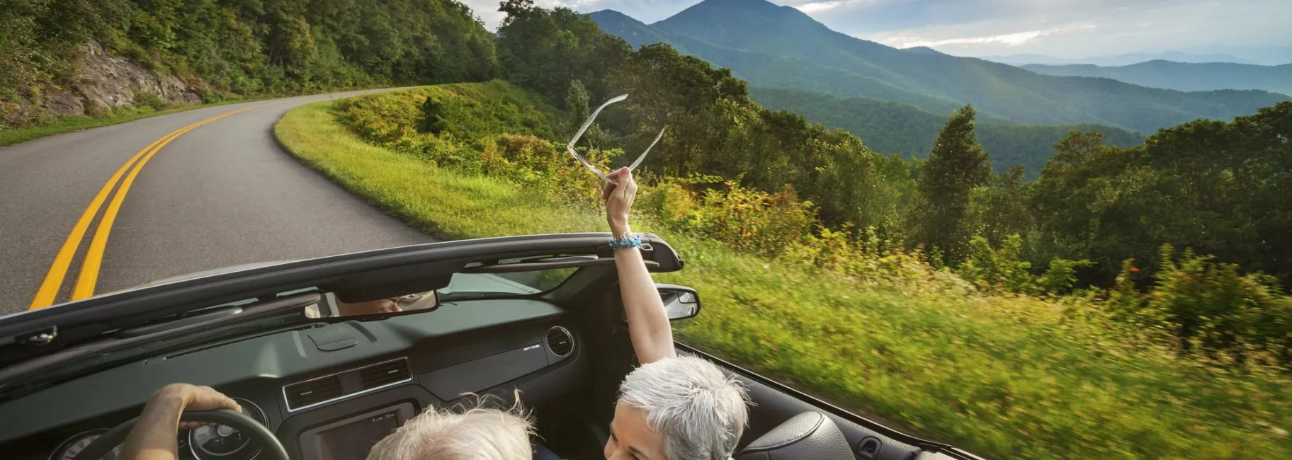 Couple in convertible on road in Asheville