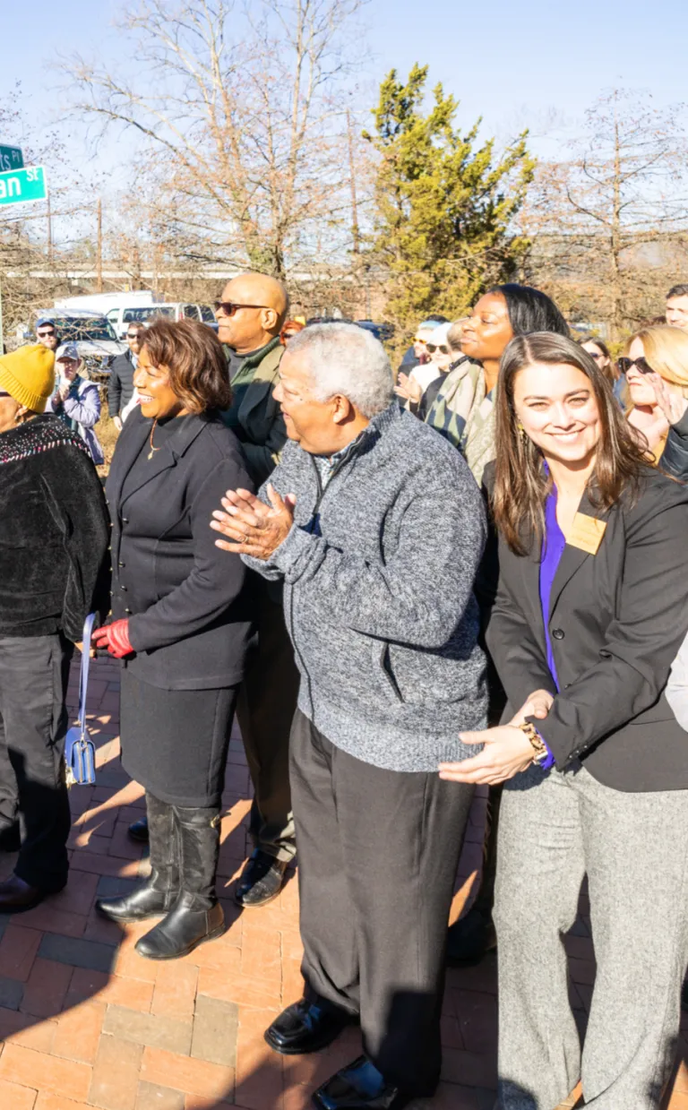 A group of people stand in a crowd.