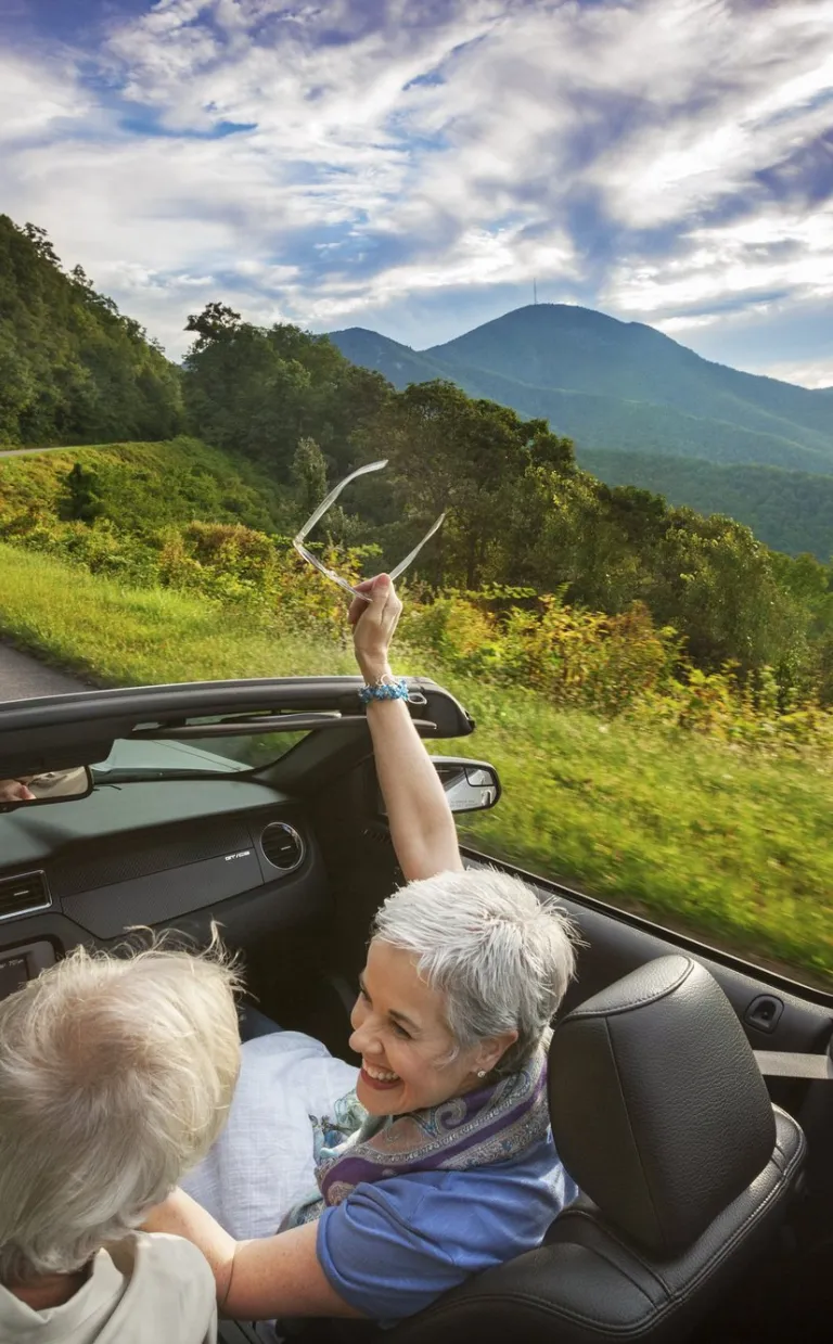 Couple in convertible on road in Asheville