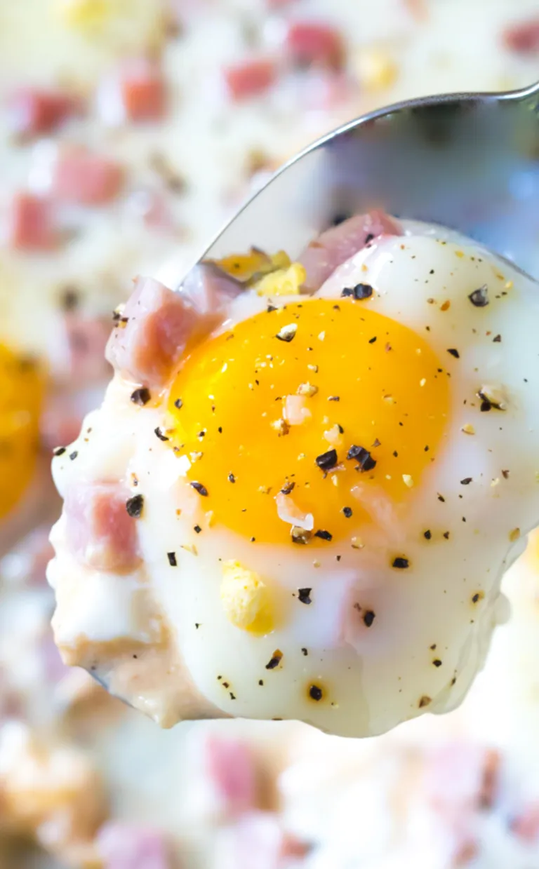 baked eggs with bright-yellow yolks sprinkled with ham