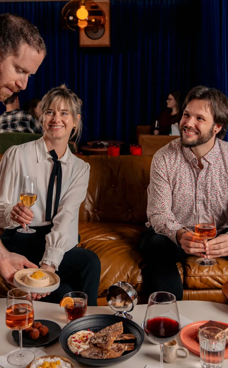 A couple enjoys wine and desserts at Potential New Boyfriend.